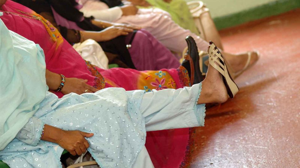 Woman from the South Asian Community participate in chair exercises during a Health Advice day Keighley UK Yorkshire